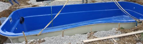fiberglass swimming pool set into hole