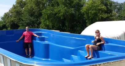 couple sitting in a fiberglass swimming pool