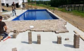 pavers around a fiberglass swimming pool